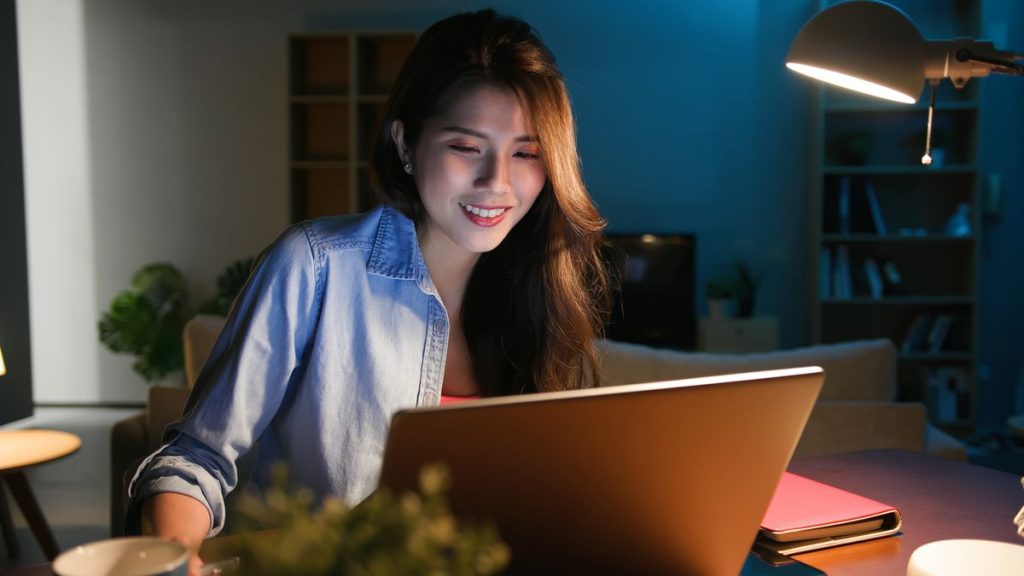 Person using a laptop looking happy